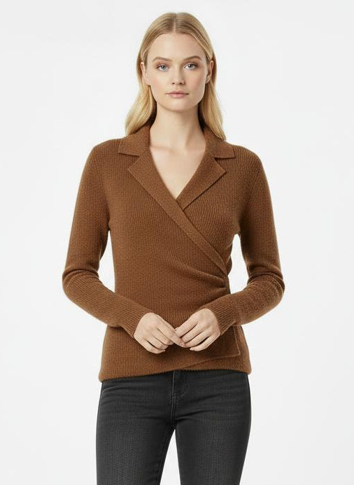 Woman wearing a brown wrap top and black jeans on a white background