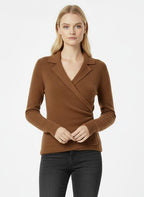 Woman wearing a brown wrap top and black jeans on a white background
